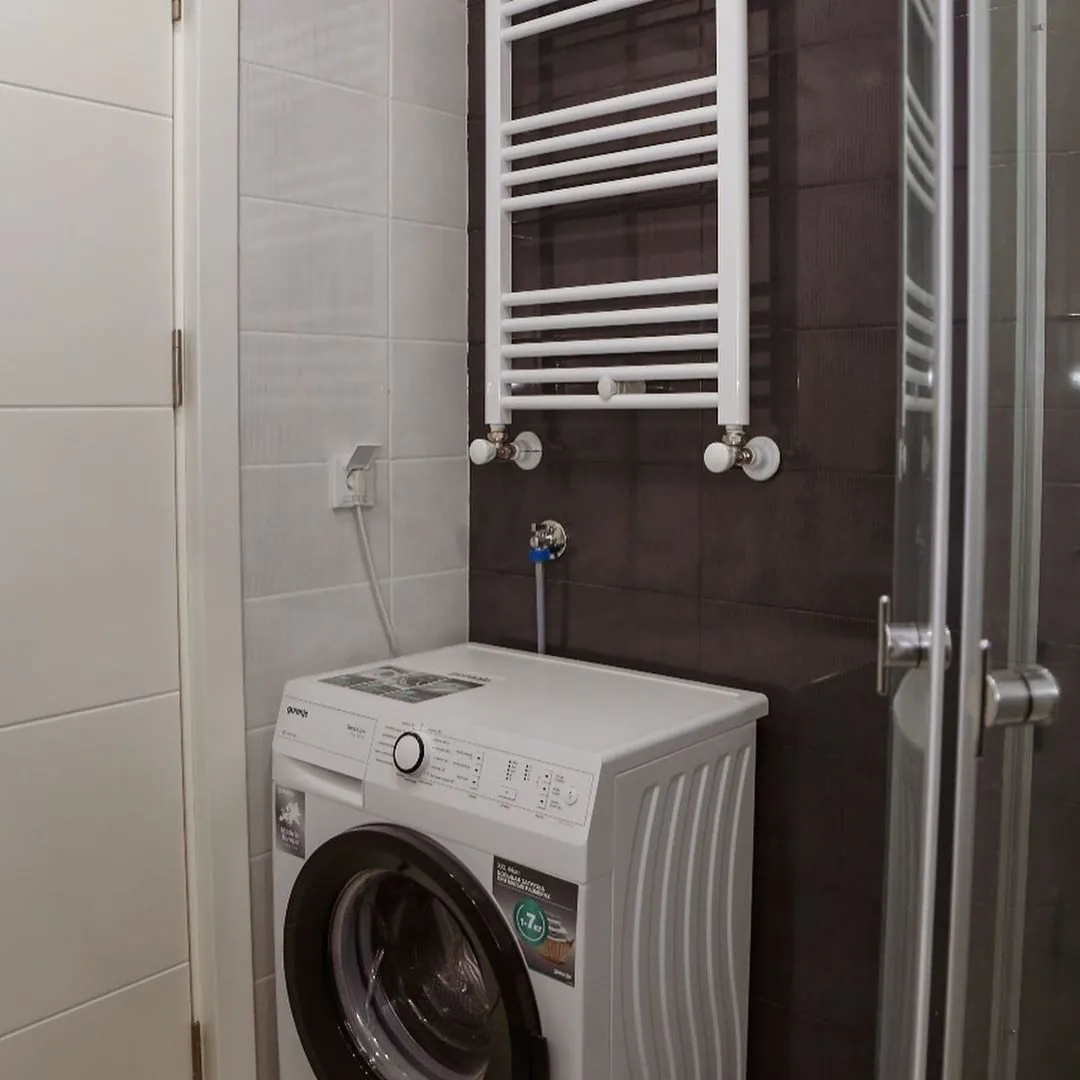 Washing machine and heated towel rail in the apartment bathroom