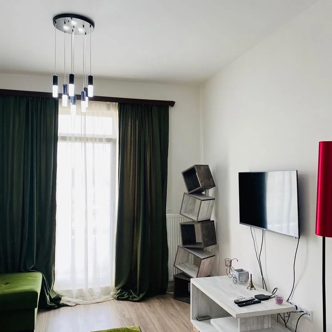 Apartment living room with a television and balcony doors