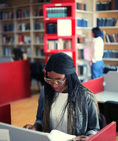 A woman studying at a library desk